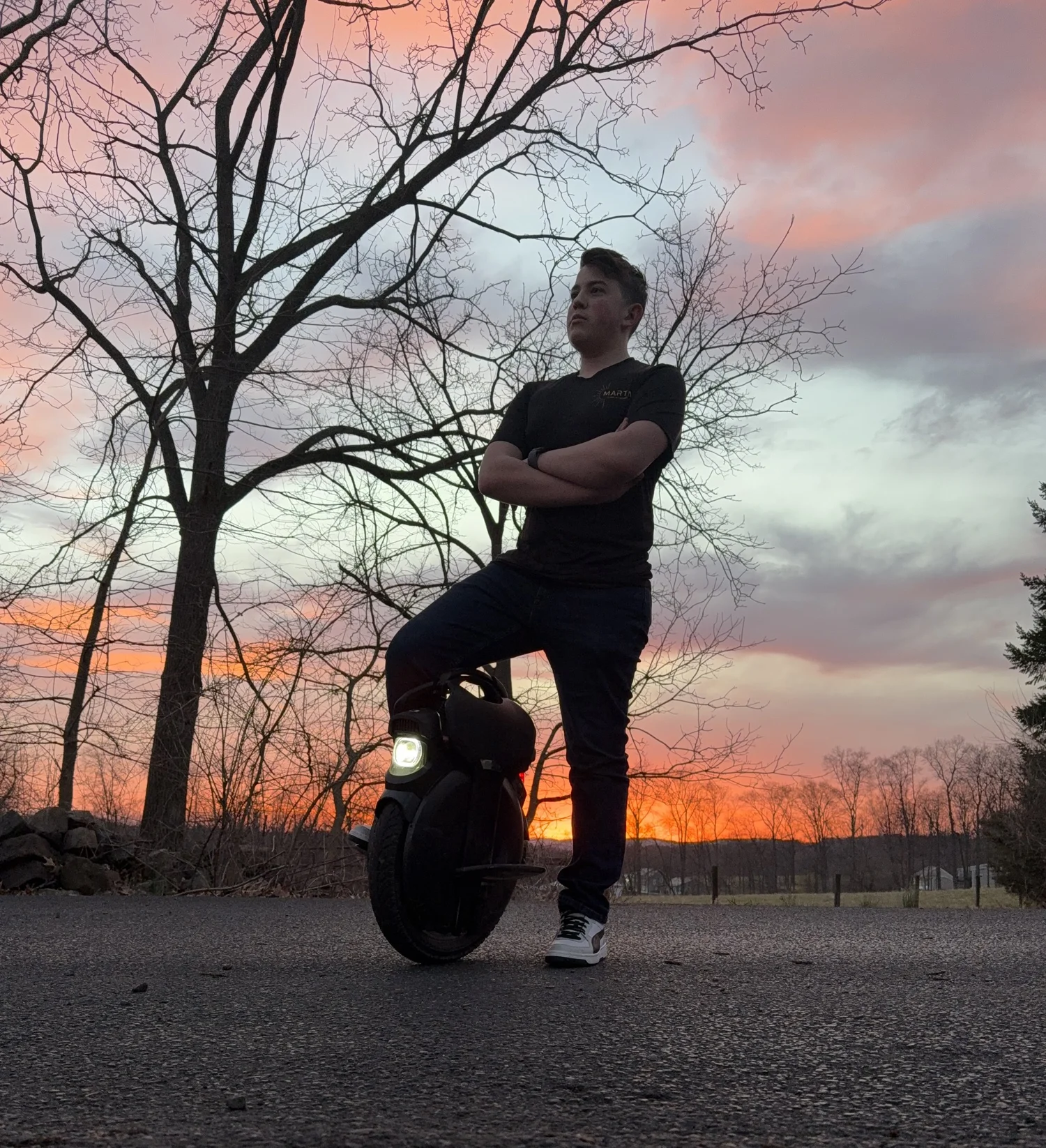 Jeff Fisher, founder of Built by Design Studio, beside his electric unicycle at sunset